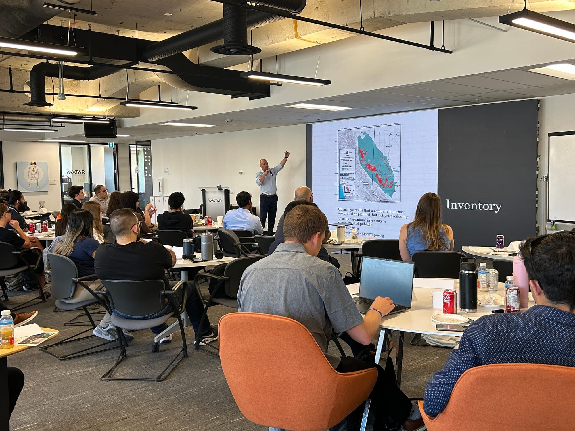 Brendan MacDougall teaching a well inventory module to a large classroom of participants.